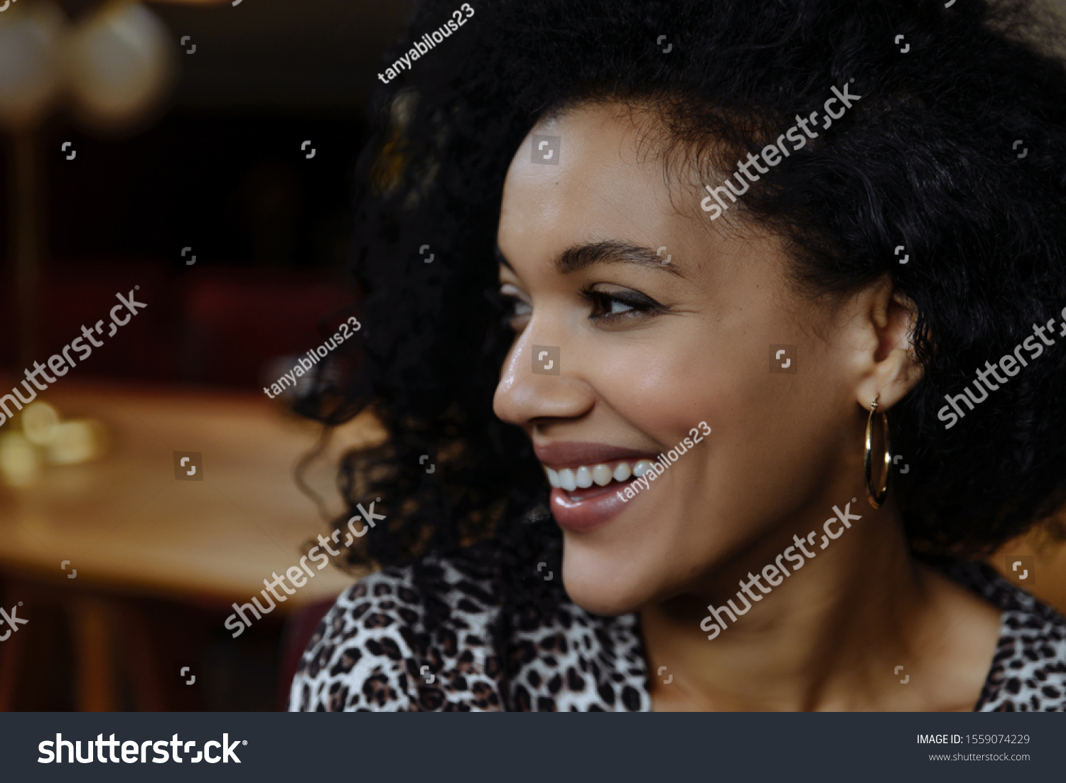 Portrait of beautiful African American girl with coffee. Close up portrait of beautiful young black woman smiling. Happy cheerful beautiful african girl in leopard print dress smiling looking at camer #1559074229