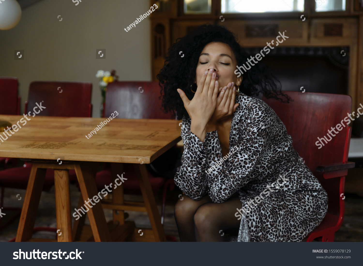 Portrait of beautiful African American girl with coffee. Portrait of beautiful young black woman smiling. Happy cheerful beautiful african girl in leopard print dress enjoy sleeps #1559078129