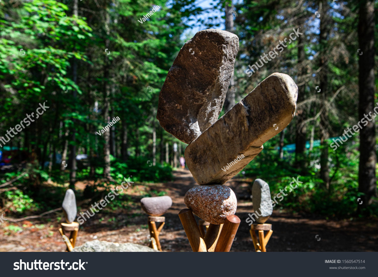 Rock balancing or stone balancing, selective focus of Balanced Stones in the forest #1560547514