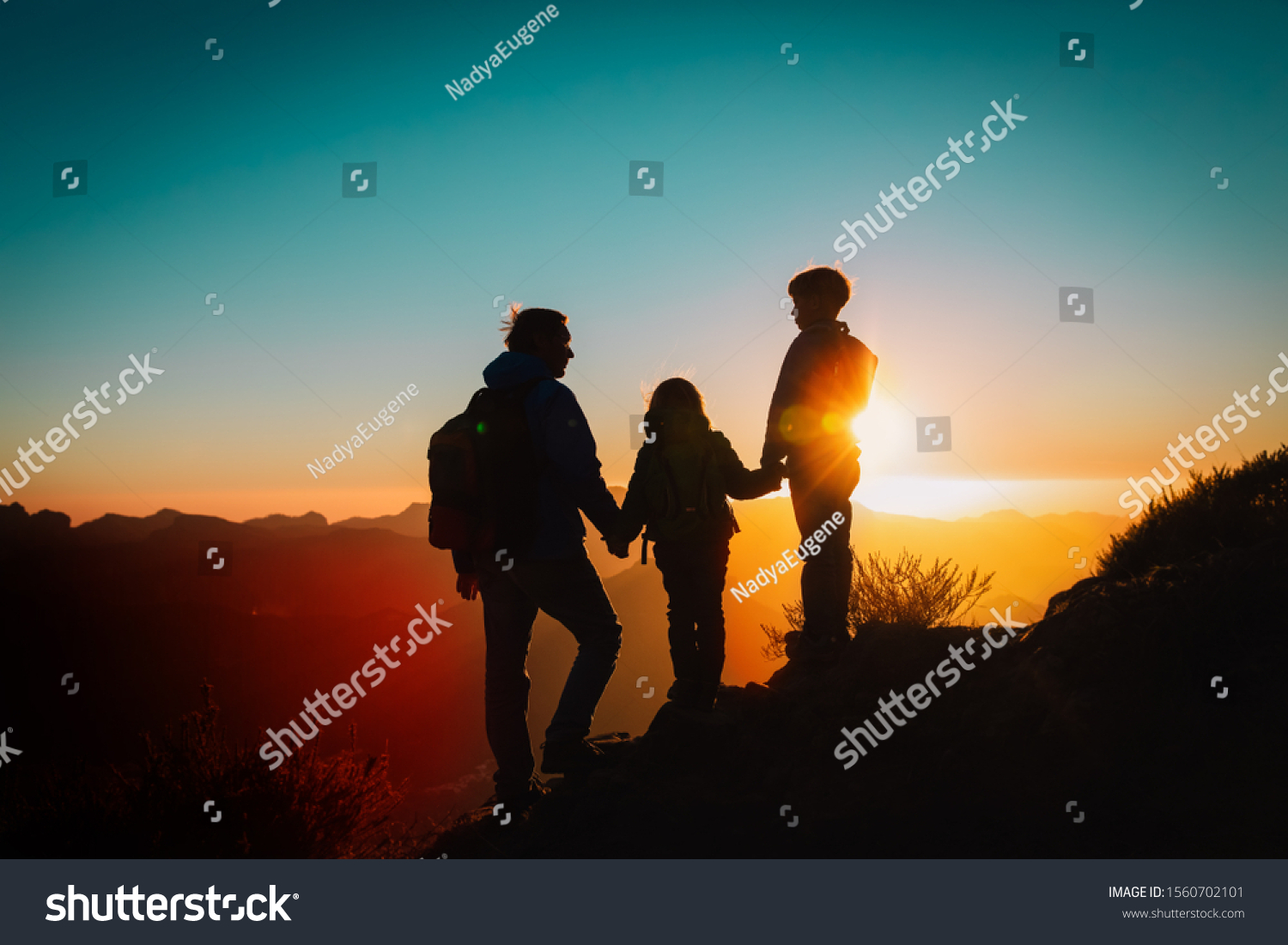 Father with kids-boy and girl- travel in sunset mountains #1560702101