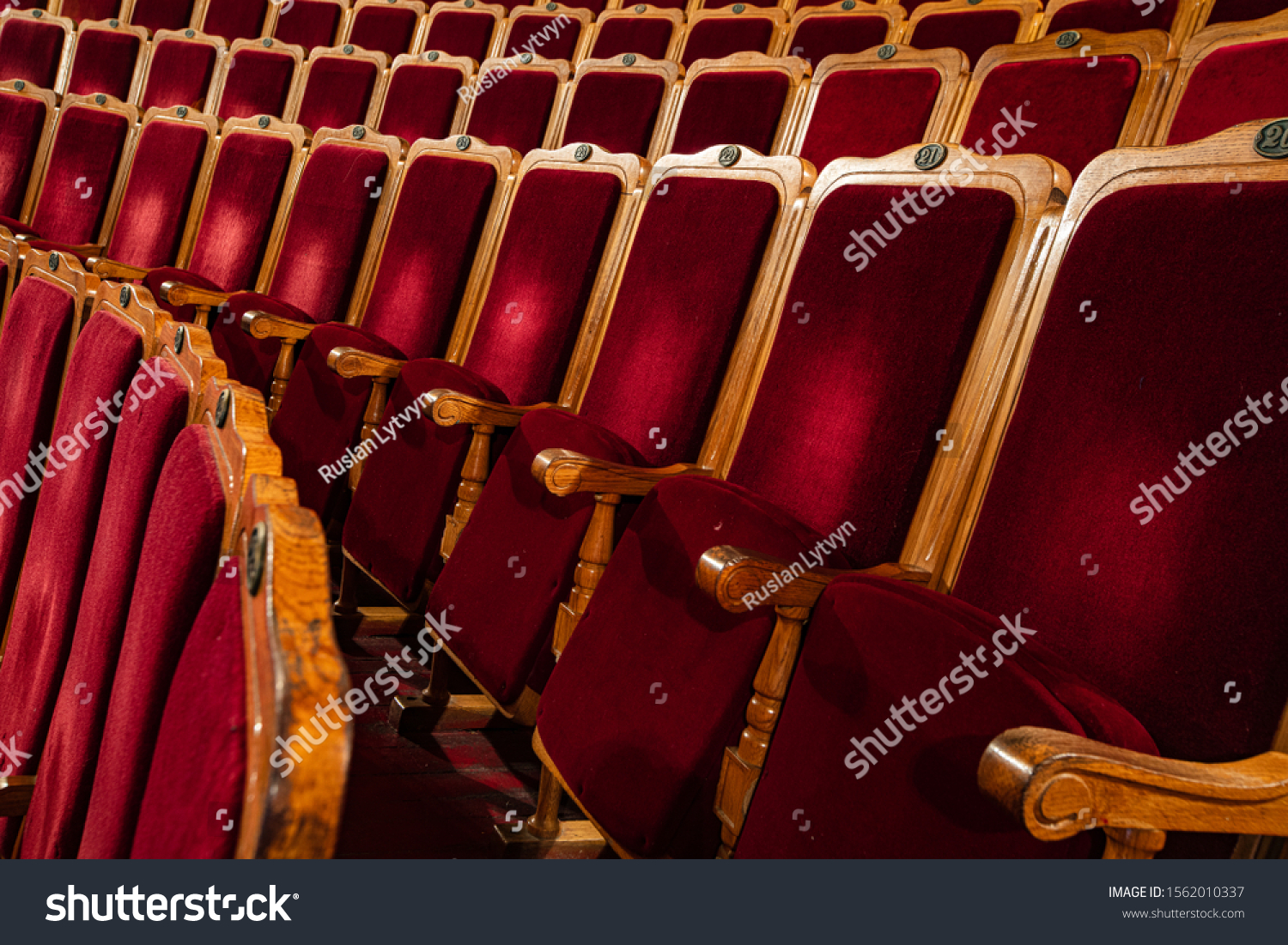 Row of red seats in theatre #1562010337