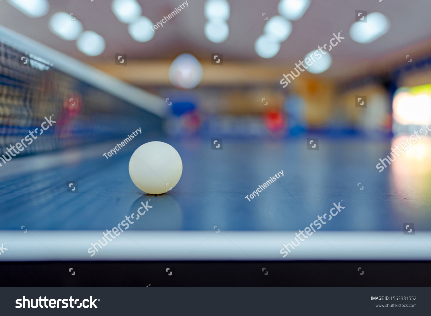 Ball on table tennis sport or ping pong on table and blurred background in activity game, net on table for competition championship  #1563331552