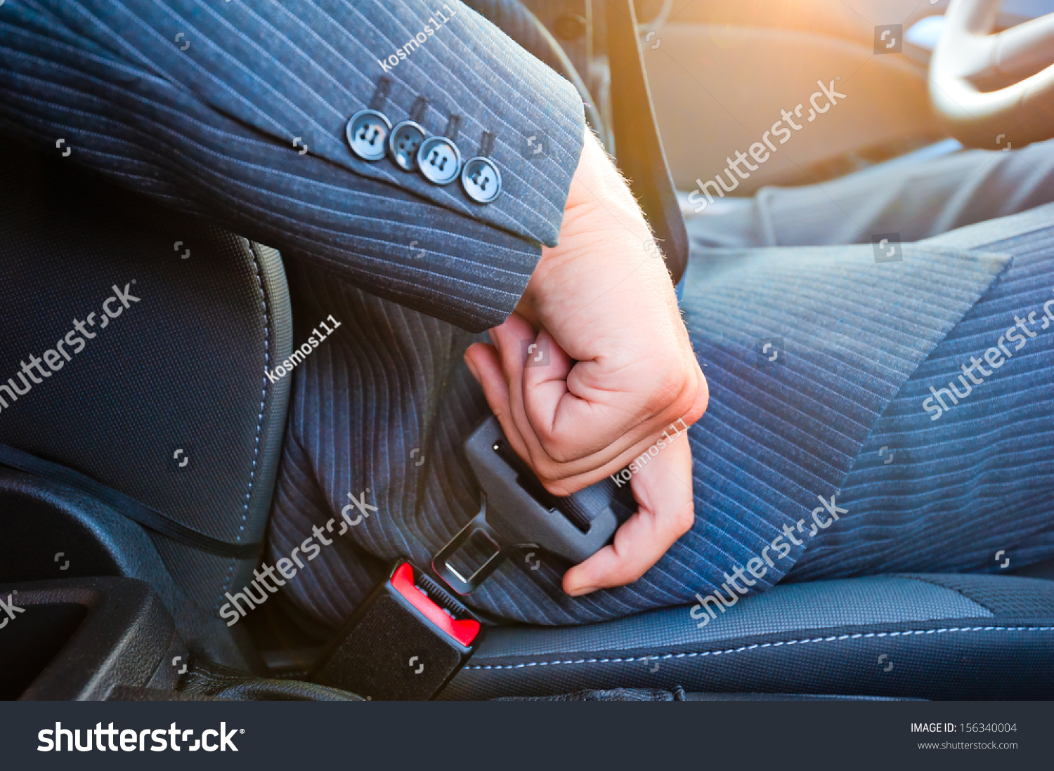 Driver in business suit fastens his seat himself automobile seat belt #156340004