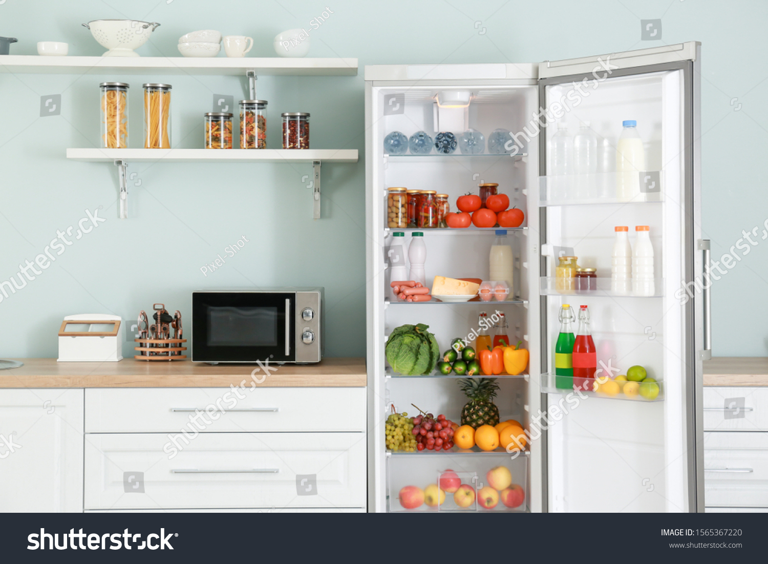 Open big fridge with products in kitchen #1565367220