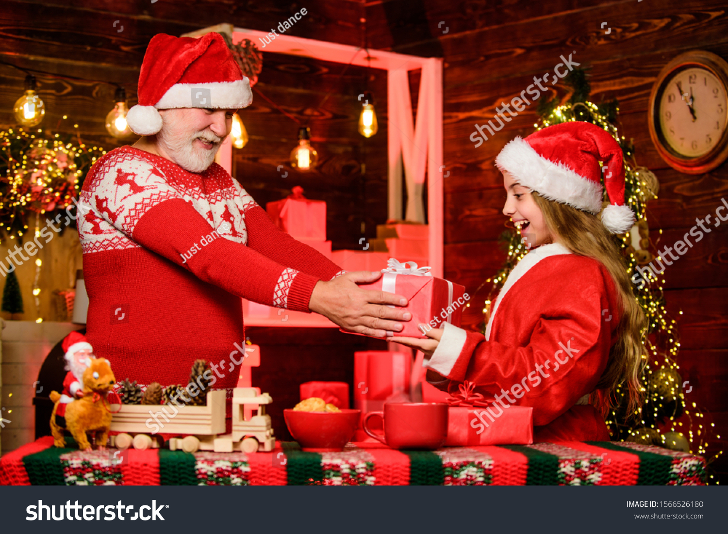 Santa Claus generous. Happiness and joy. Rewarding kindness. Santa bring gifts little girl. Cheerful celebration. Festive tradition. Child enjoy christmas with bearded grandfather Santa claus. #1566526180