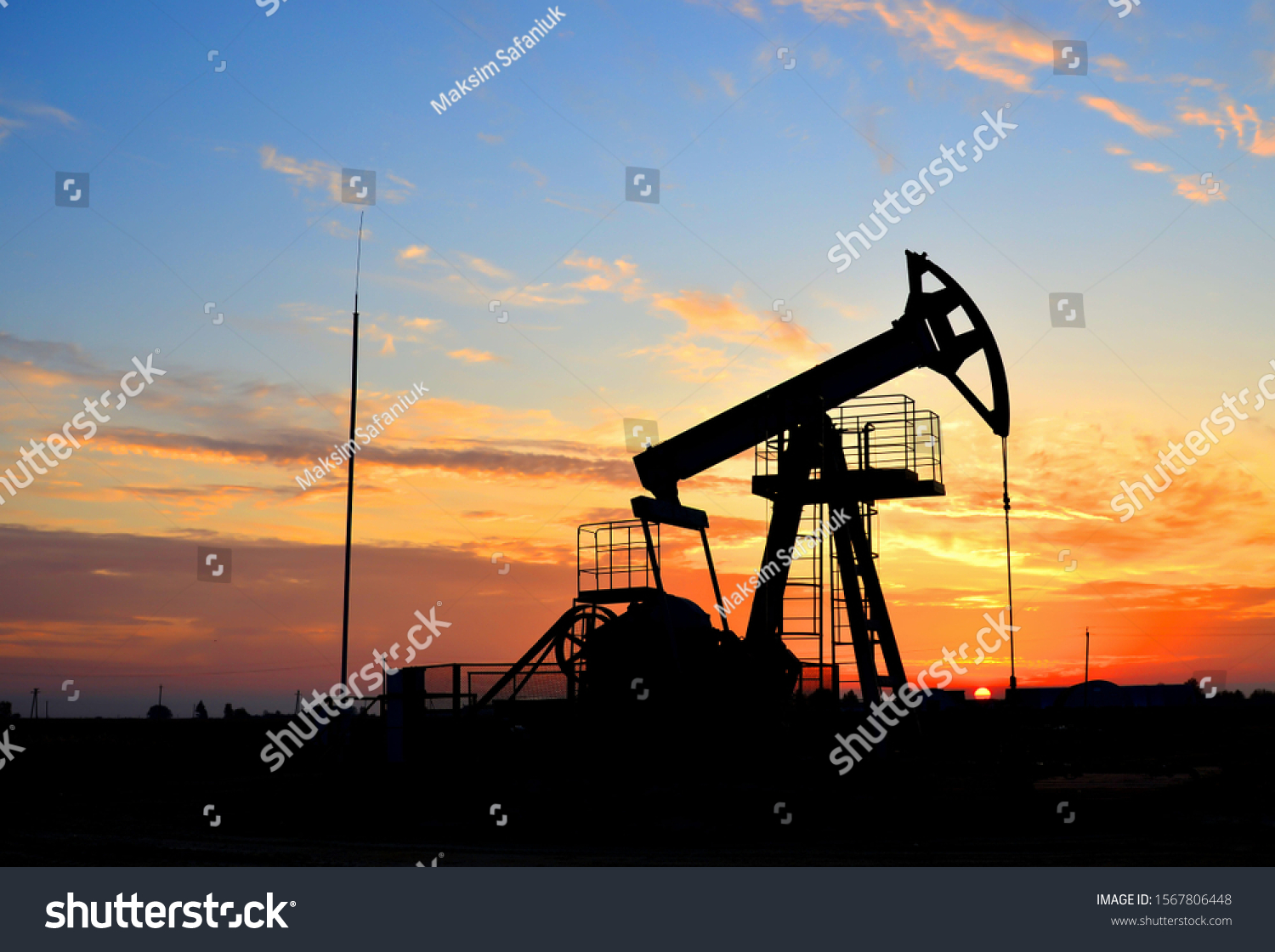Oil drilling derricks at desert oilfield for fossil fuels output and crude oil production from the ground. Oil drill rig and pump jack background, texture. Belarus, Rechitsa region #1567806448