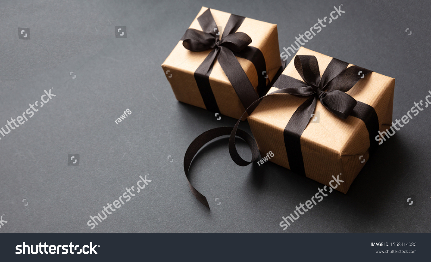 Black Friday sale concept. Gift boxes with black ribbon isolated against black background, high angle view #1568414080
