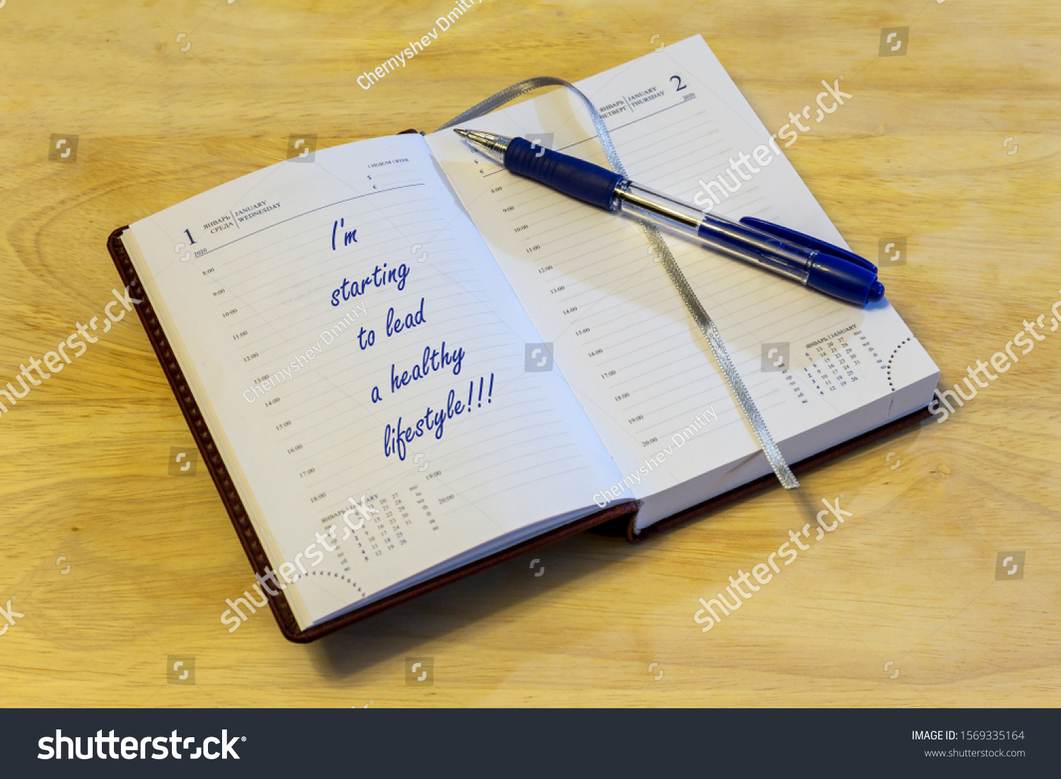The diary is on the table. The diary is open on the first of January page. The page reads: "I'm starting to lead a healthy lifestyle!!!". #1569335164