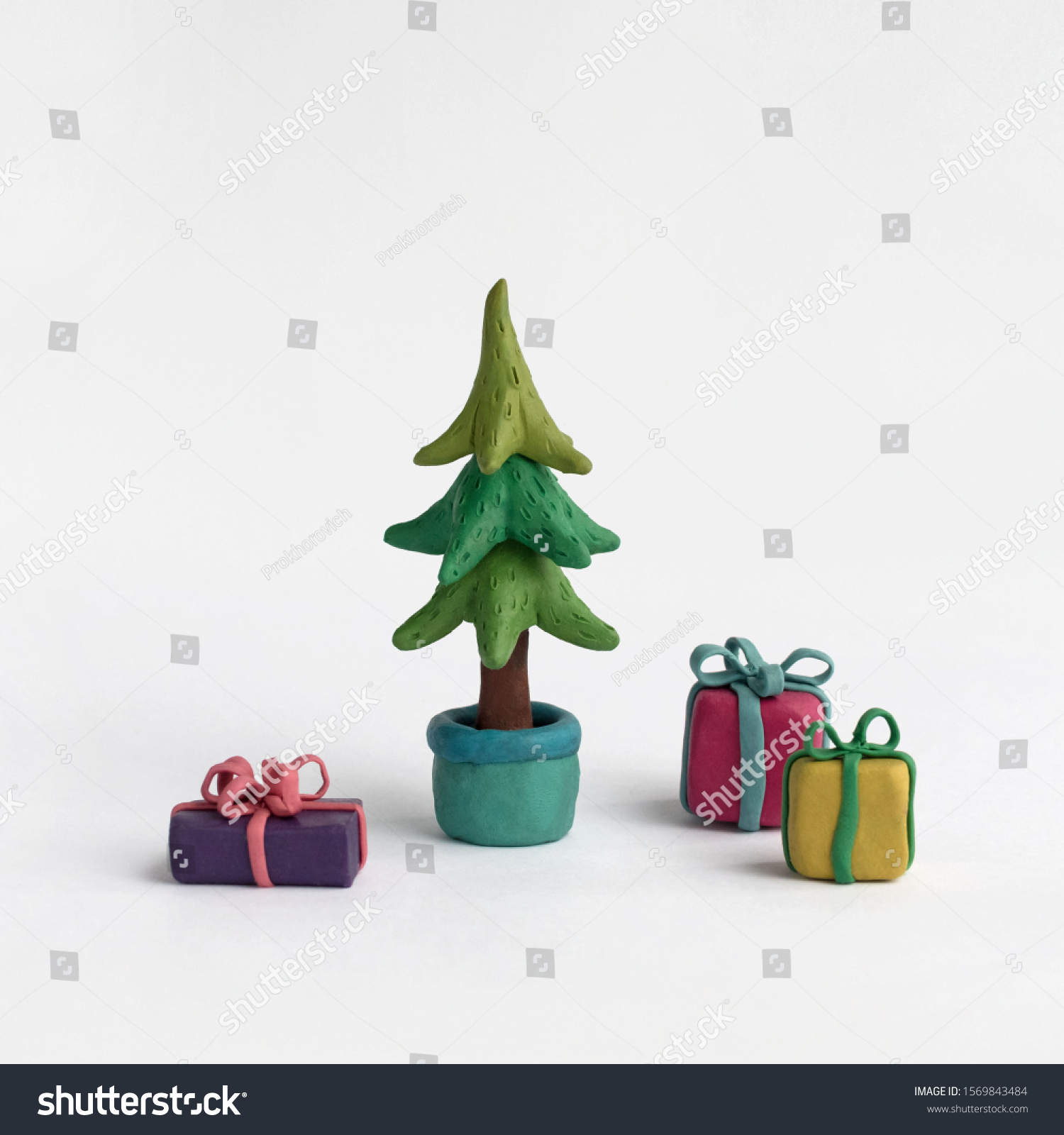 Christmas tree and gifts on a white background. Plasticine illustration #1569843484