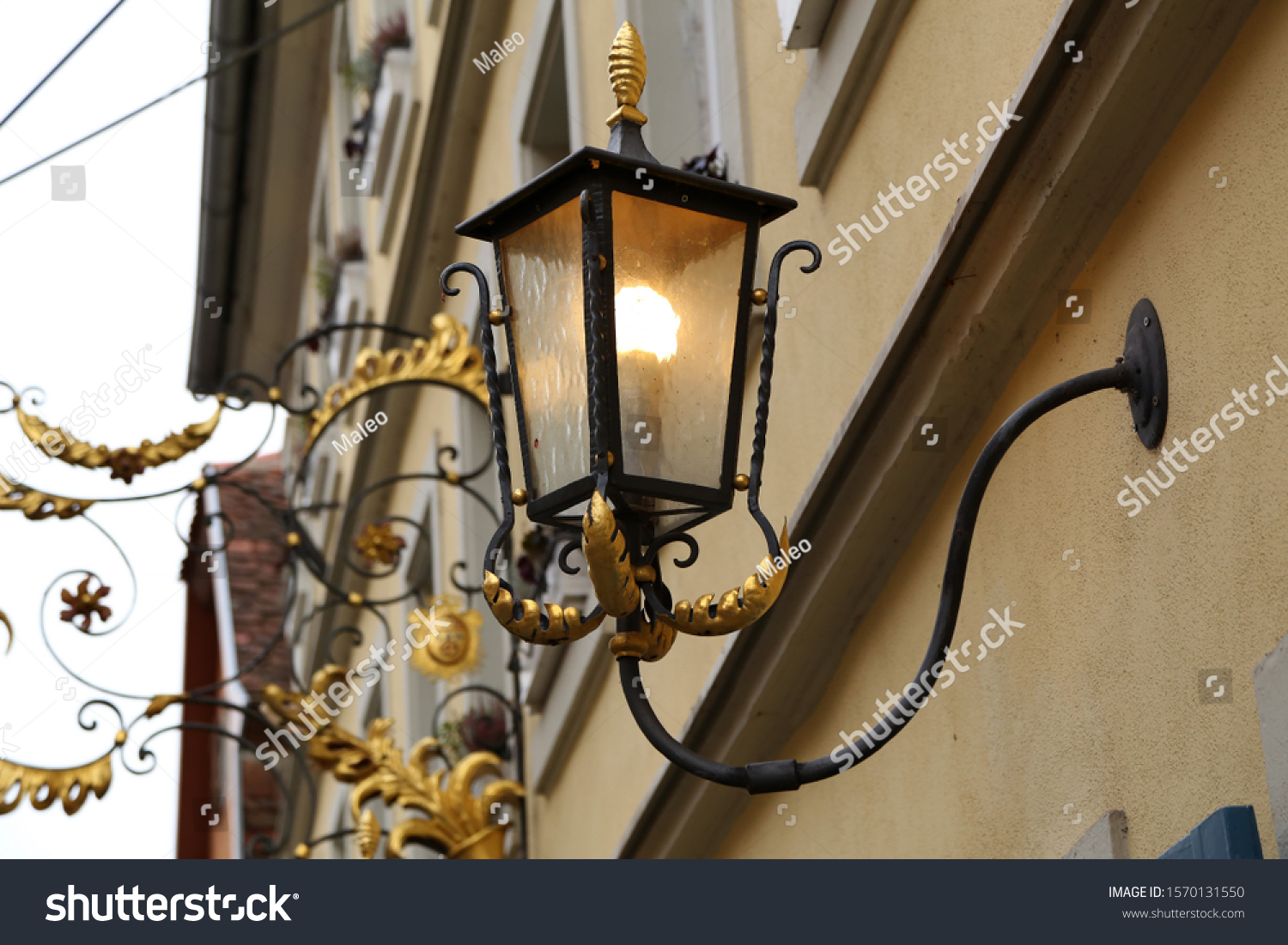 Old street lamps illuminate the way for passersby #1570131550