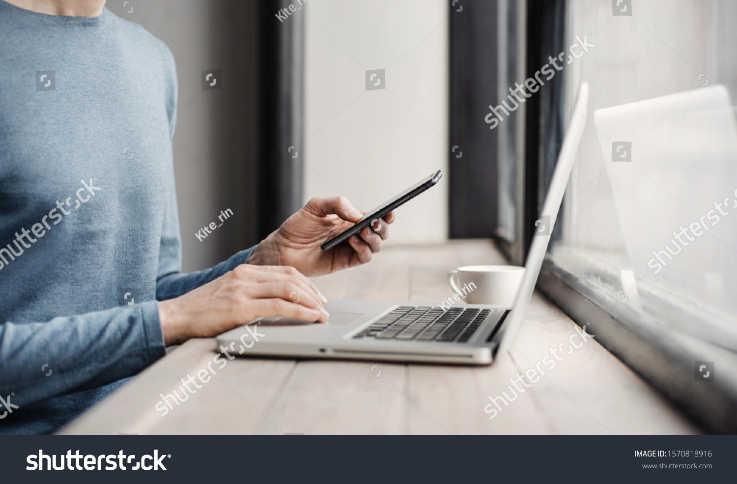 Businessman working on computer. Men using smart phone and laptop in the office. Internet marketing, finance, business concept #1570818916