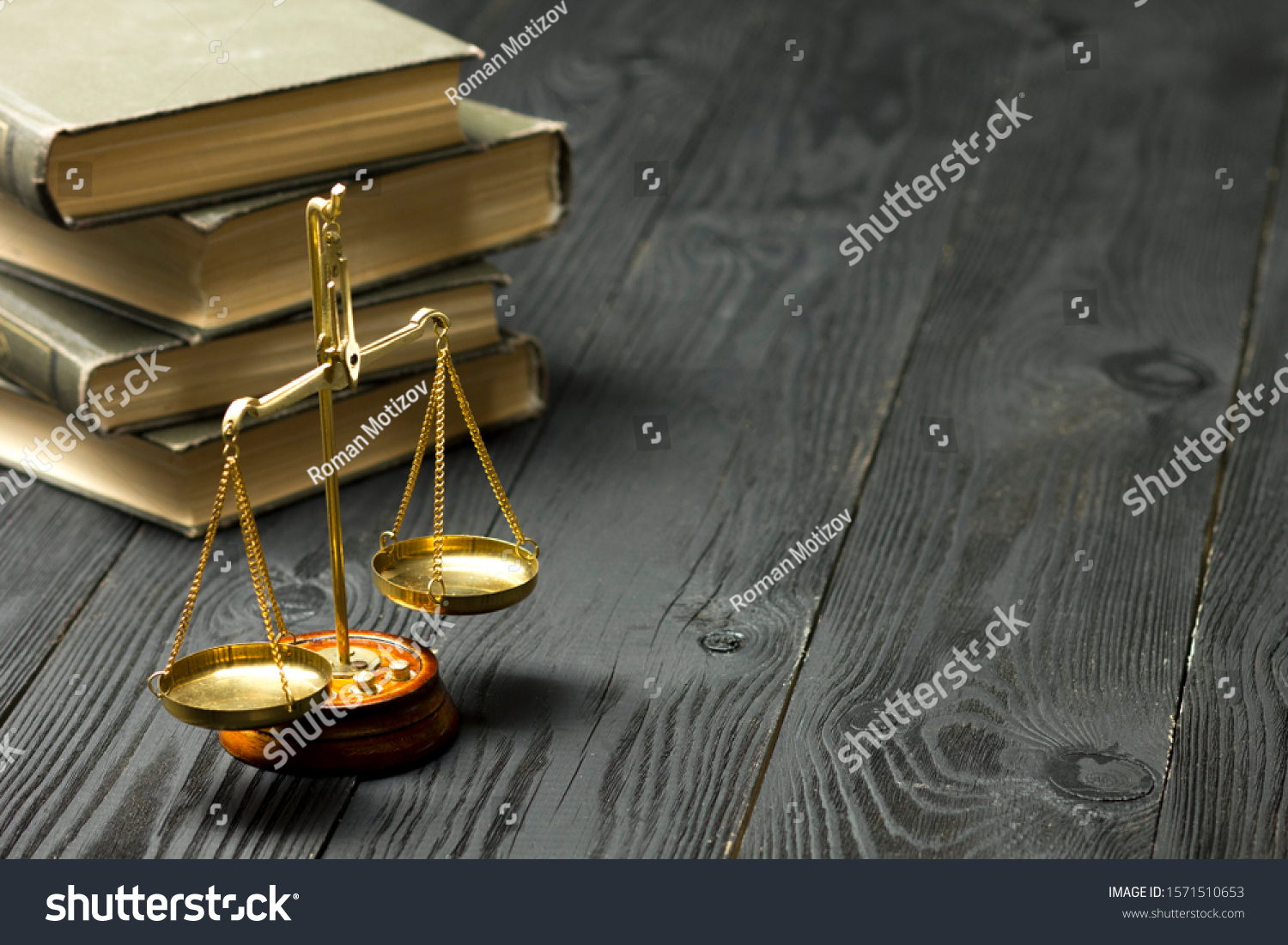 Law concept - Open law book with a wooden judges gavel on table in a courtroom or law enforcement office isolated on white background. Copy space for text. #1571510653