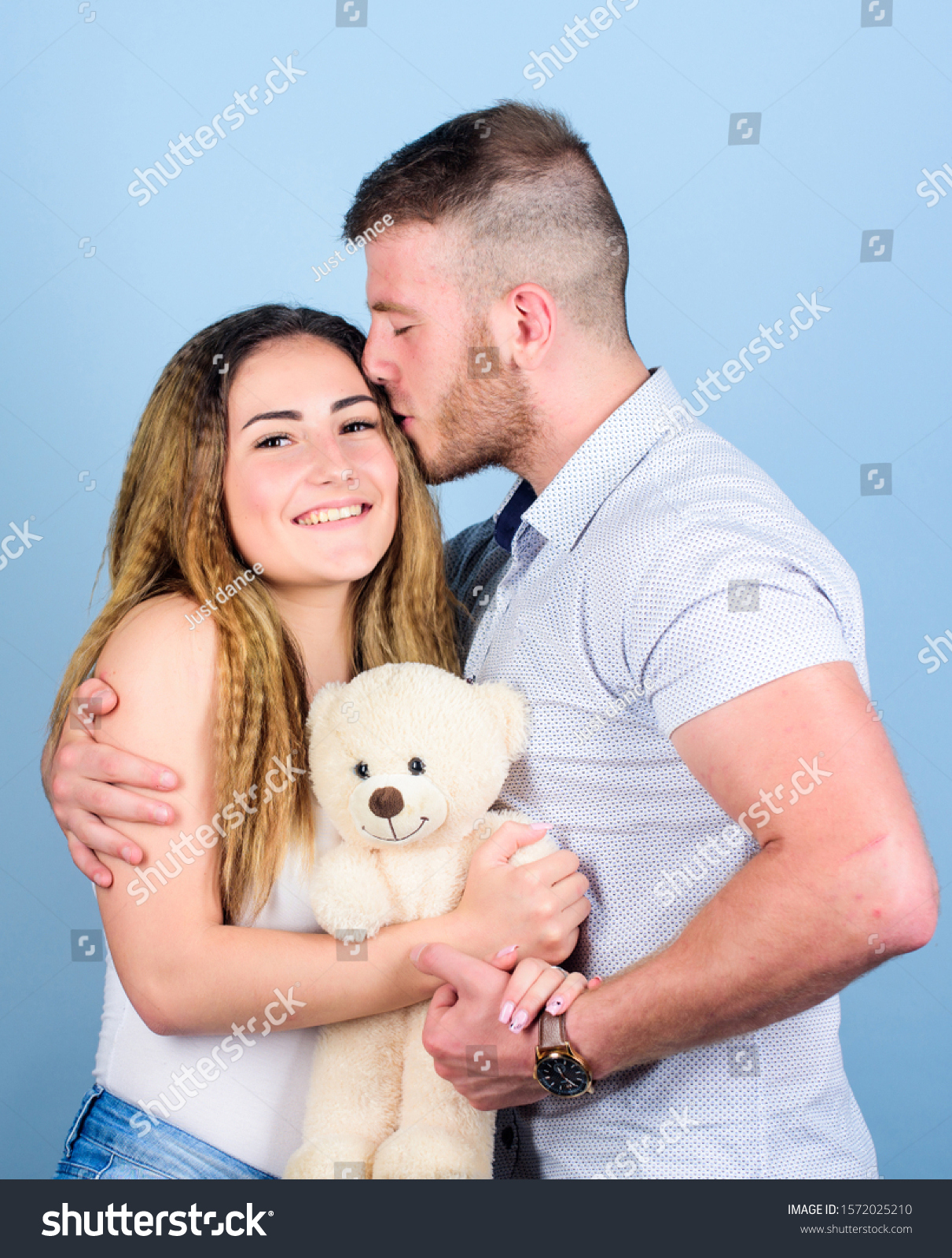 Valentines day holiday. Soft toy teddy bear gift. Man and woman couple in love. Romantic surprise. Man and pretty girl in love. Family love. Guy and girl cuddling. Enjoying each other. Happy family. #1572025210