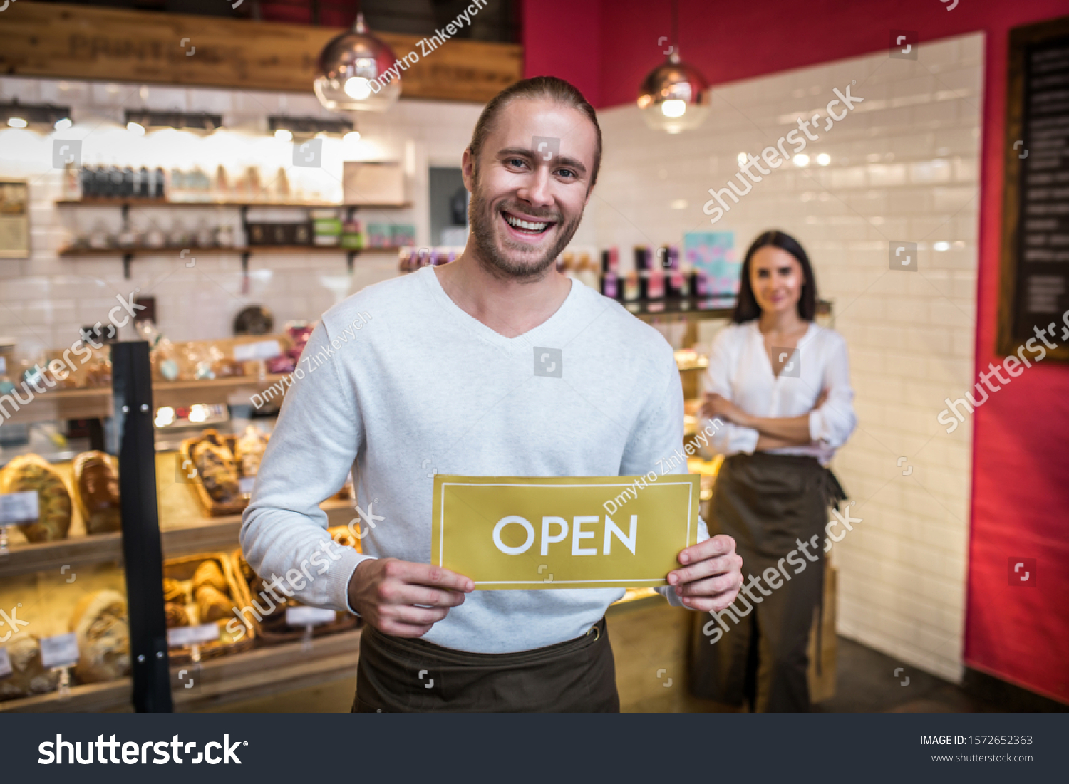 Bearded handsome man. Bearded handsome man smiling while opening pastry shop with his wife #1572652363