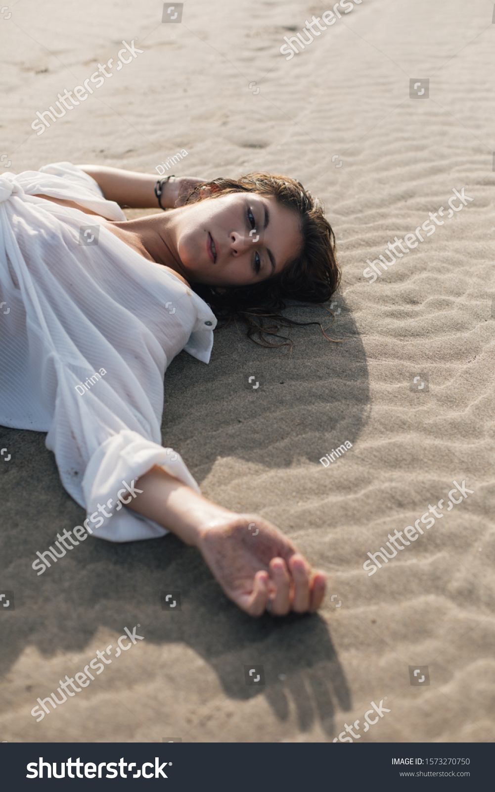 Young woman relaxing at the beach lying on the sand. Summer vacation relax and leisure concept. #1573270750
