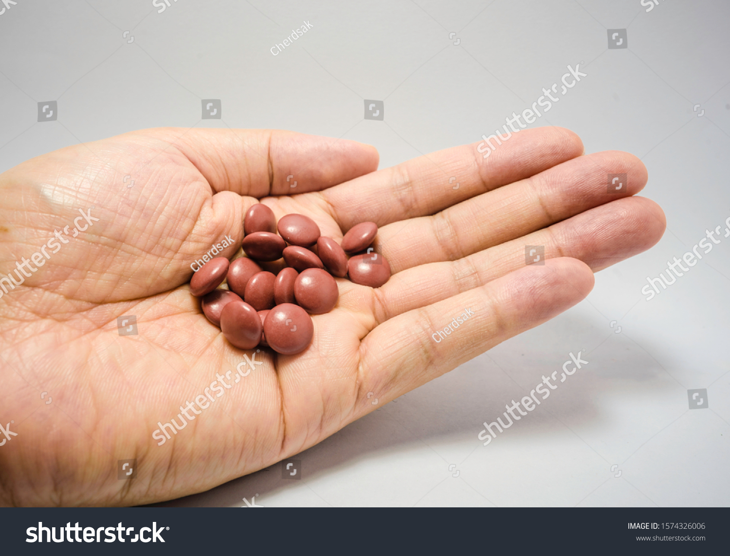Brown pills on the left hand #1574326006