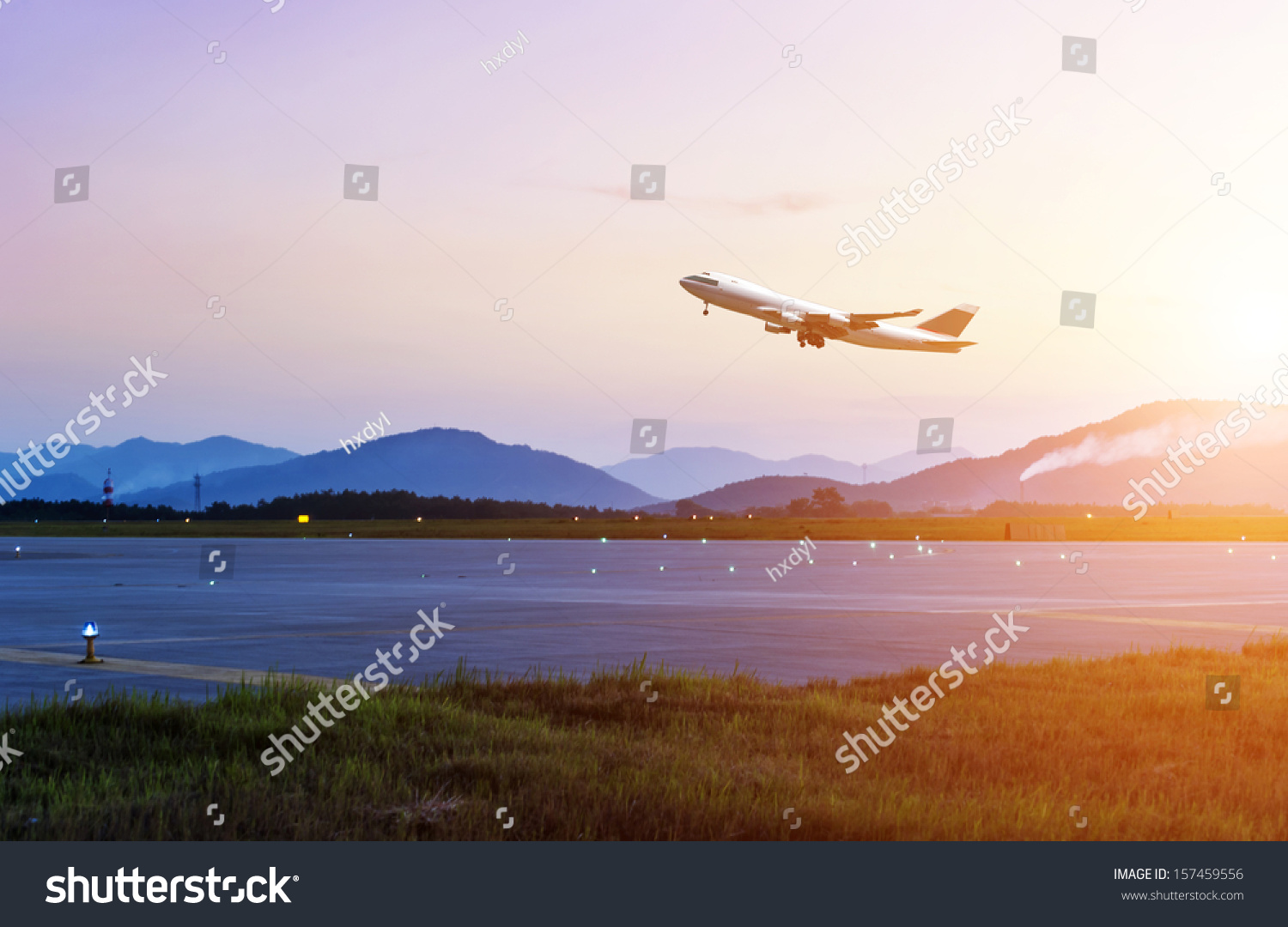 passenger plane fly up over take-off runway from airport at sunset #157459556