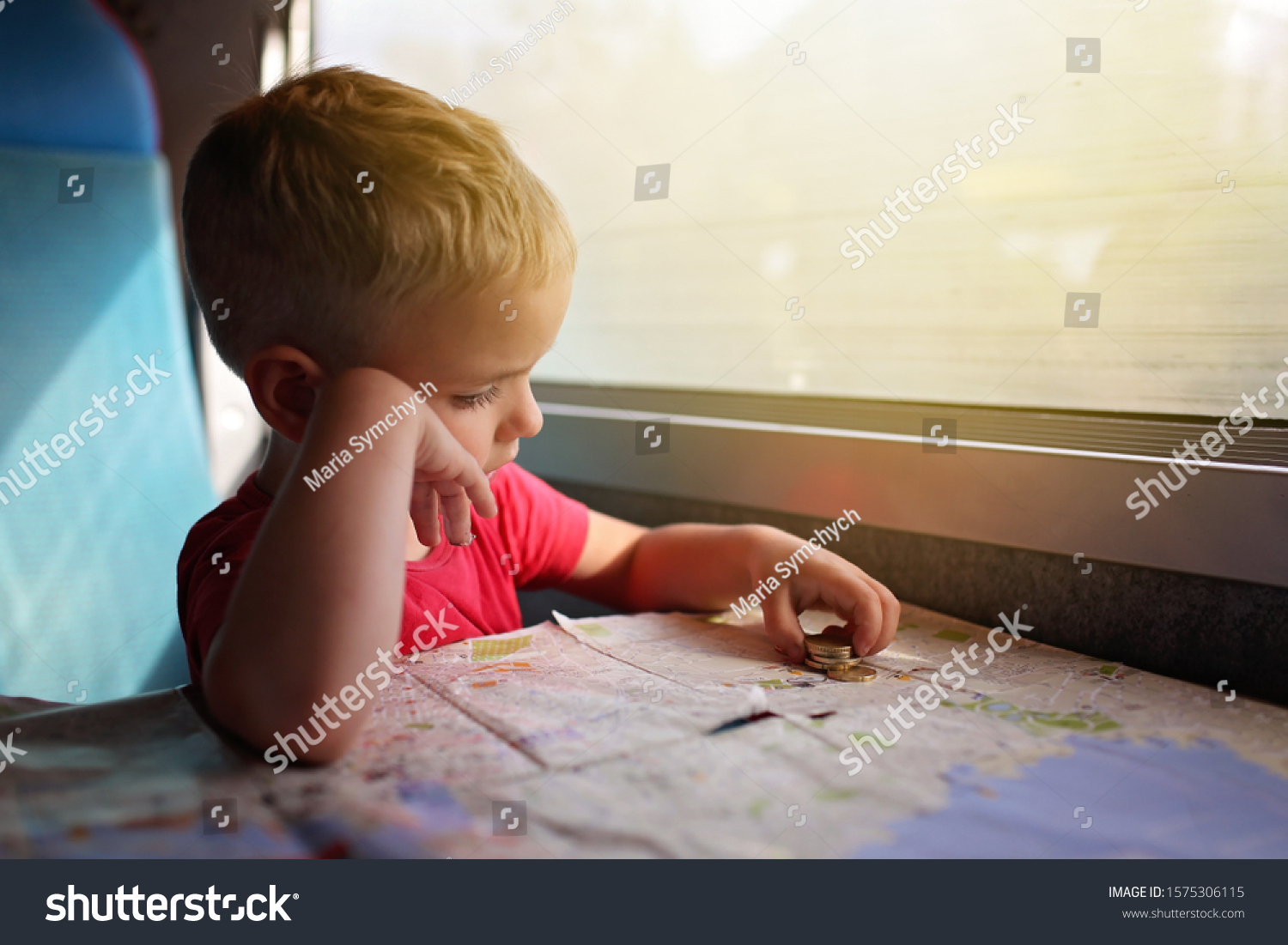Cute little boy planning his economy vacations during travelling time by train, transport, happy family vacation and summertime, lifestyle inside portrait #1575306115