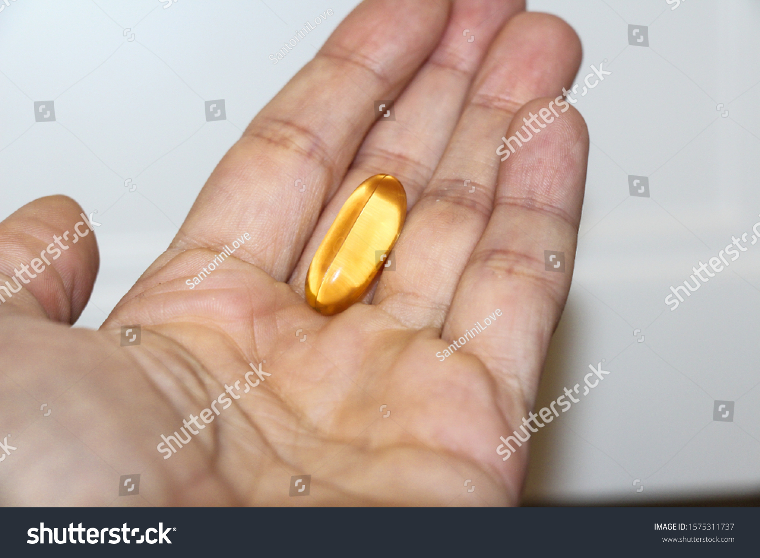 Realistic yellow gelatin capsule with omega 3. Omega-3 fish oil capsules #1575311737