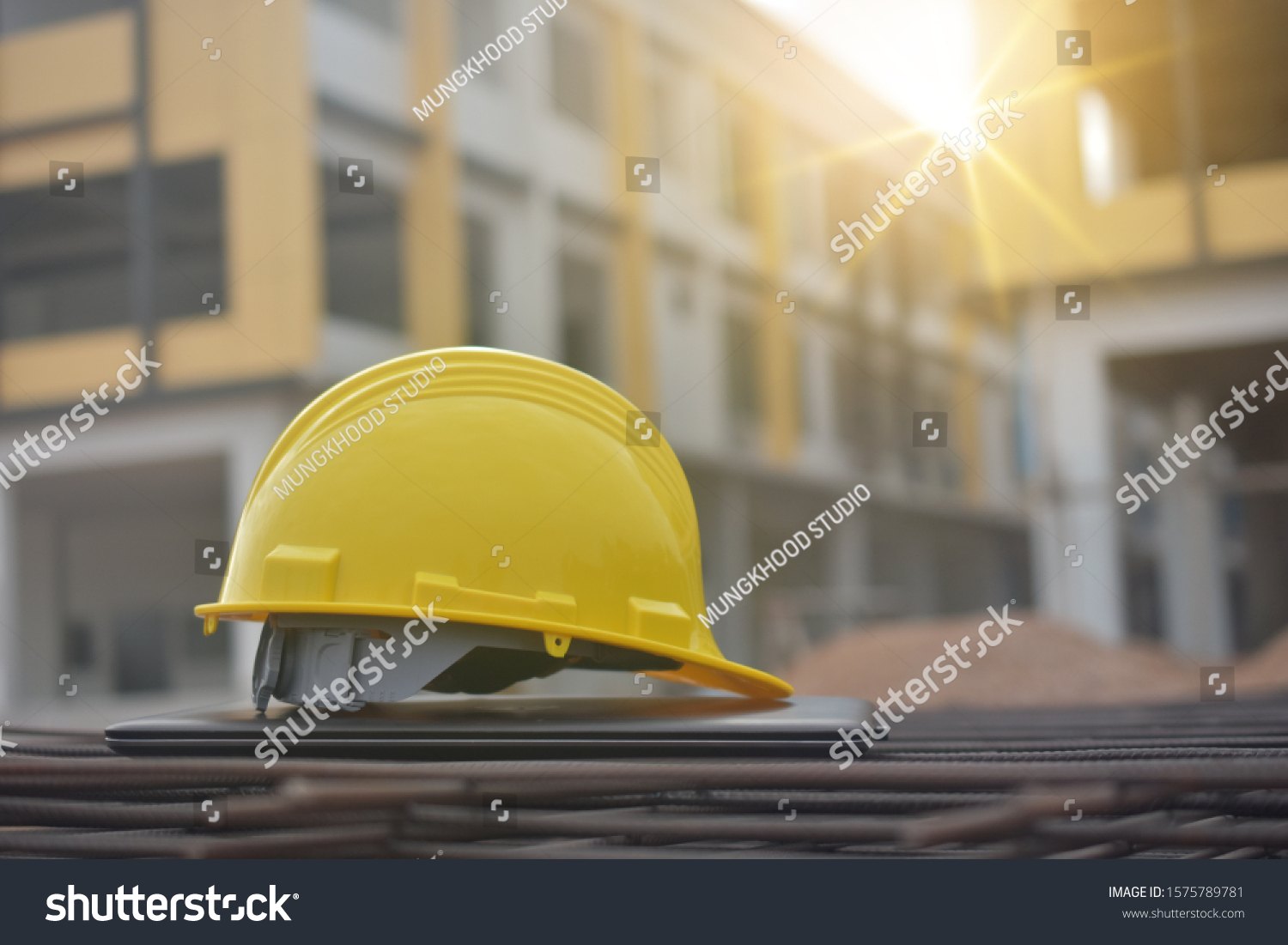Hard hat safety on computer notebook building construction estate background #1575789781