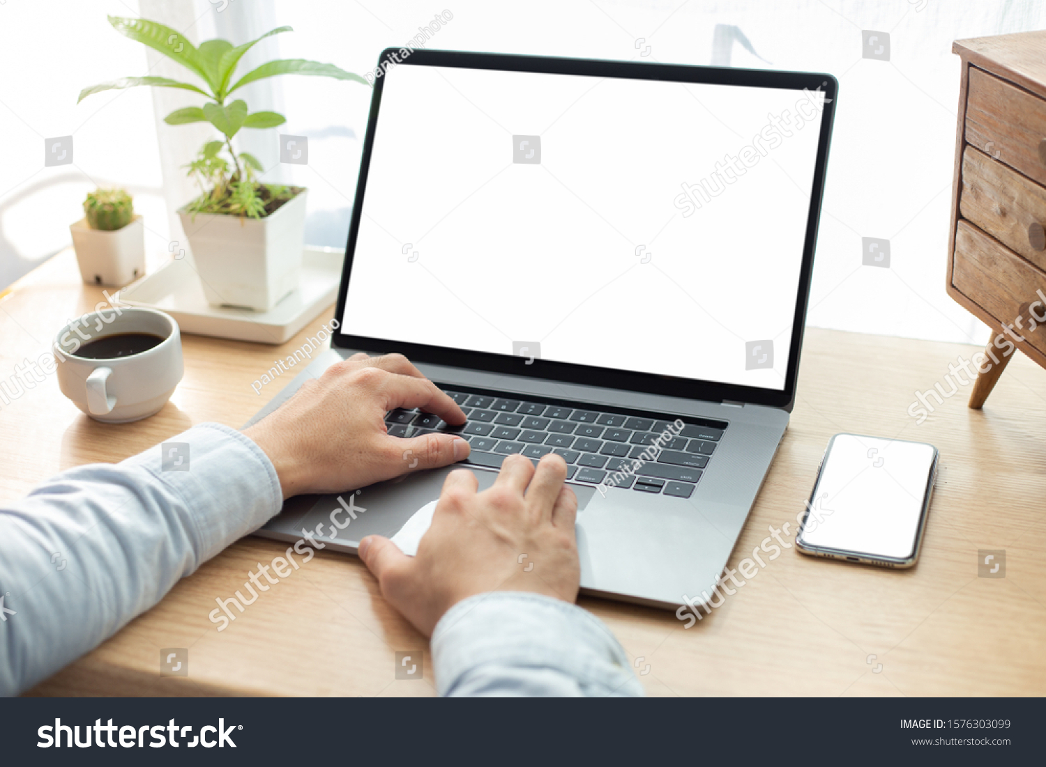 mockup image blank screen computer,cell phone with white background for advertising text,hand man using laptop texting mobile contact business search information on desk in office.marketing and design #1576303099