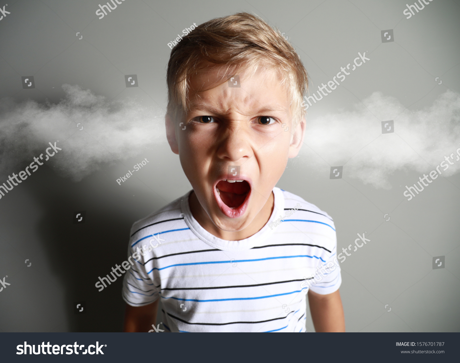 Portrait of angry little boy with steam coming out of ears on grey background #1576701787