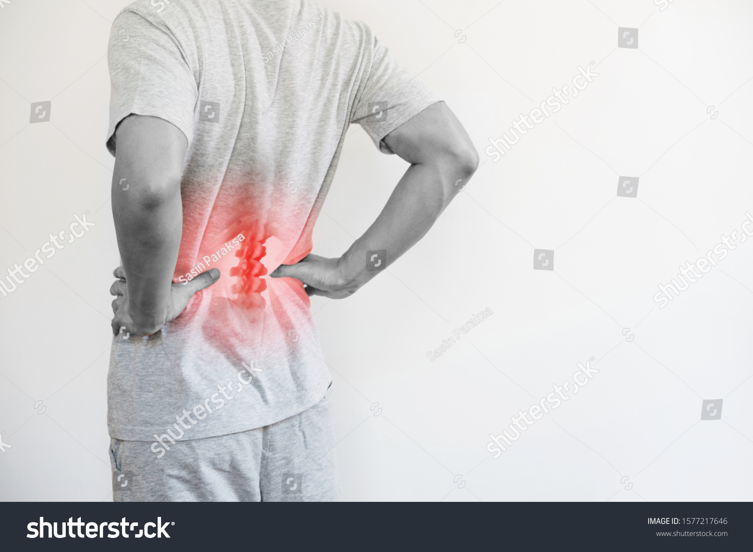 Office syndrome, Backache and Lower Back Pain Concept. a man touching his lower back at pain point #1577217646