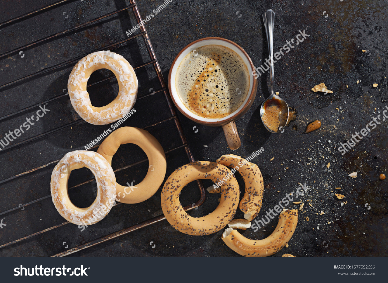 Freshly baked bagels and cup of coffee on a metal baking tray baking tray, top view #1577552656