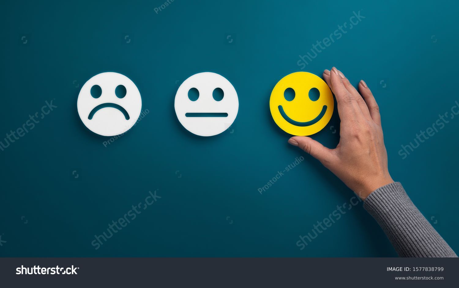 Rating concept. Woman choosing happy smile face emotion on blue background, panorama, copy space #1577838799