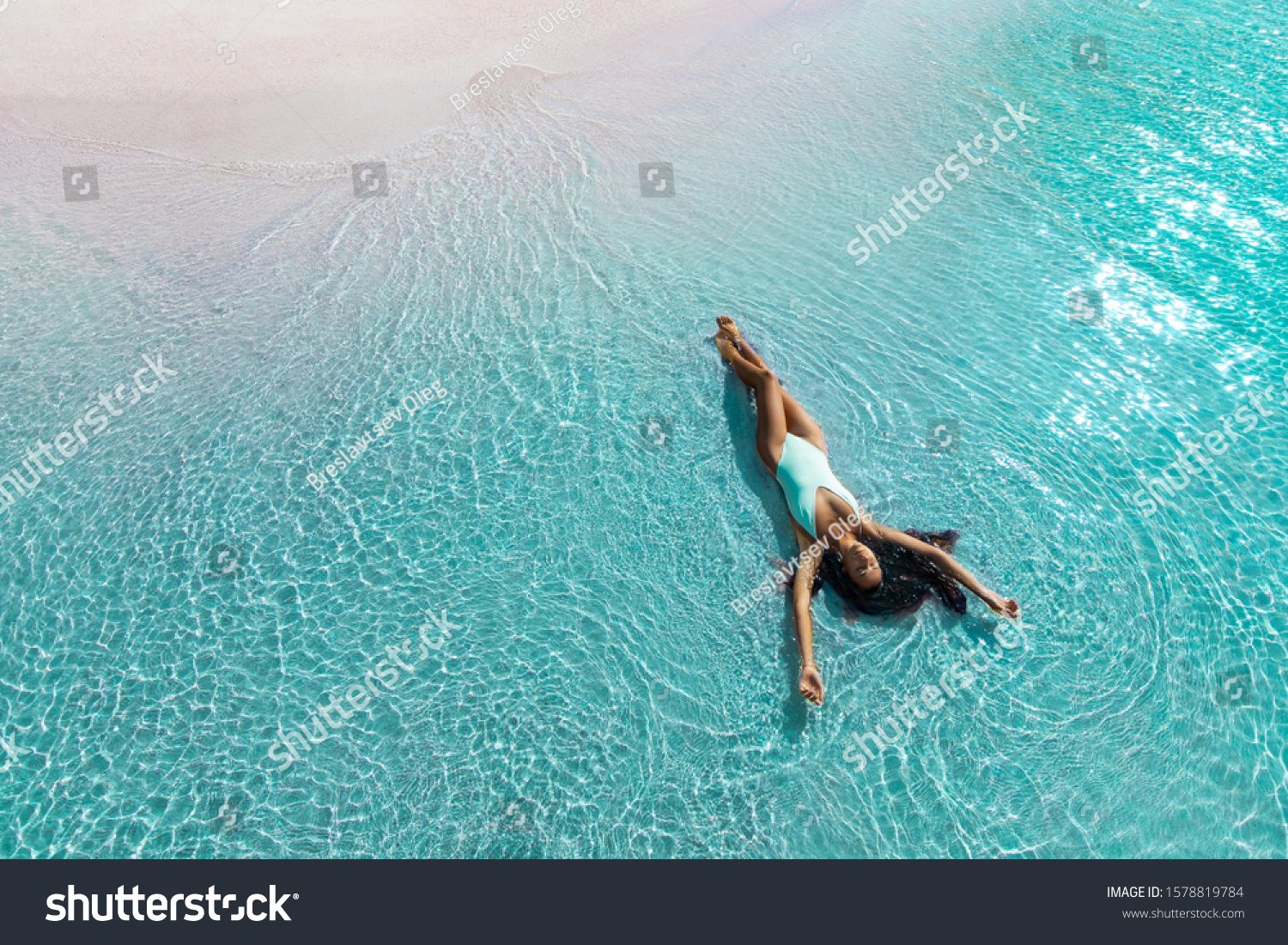 Beautiful slim woman lying on the beach in white swimsuit. Aqua Menthe trendy color of the new year 2020. Leisure island vacations concept. #1578819784