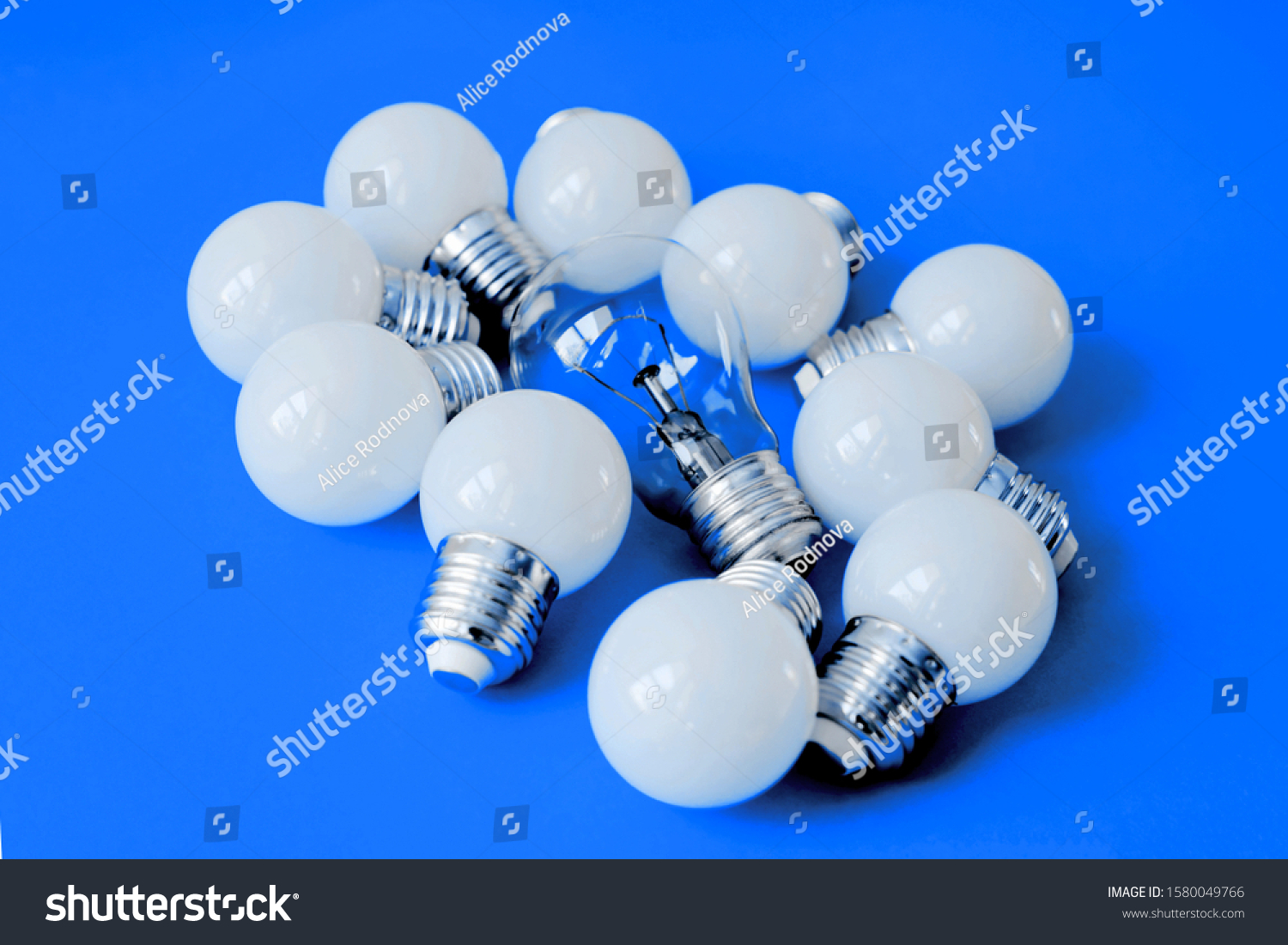 LED lamps on Color of the year 2020 Classic Blue background. Lamps, LED lamps and fluorescent lamps on blue background. White energy-saving light bulbs. Light bulbs lie in a row. #1580049766
