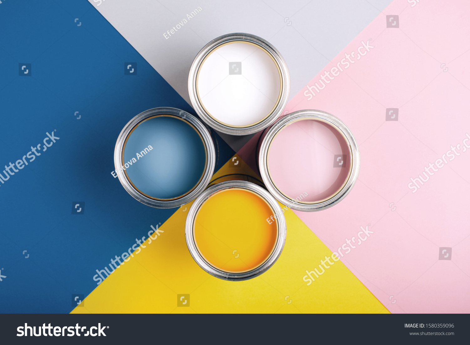 Four open cans of paint on bright symmetry background. Yellow, white, pink, blue colors of paint. Place for text. Renovation concept. #1580359096