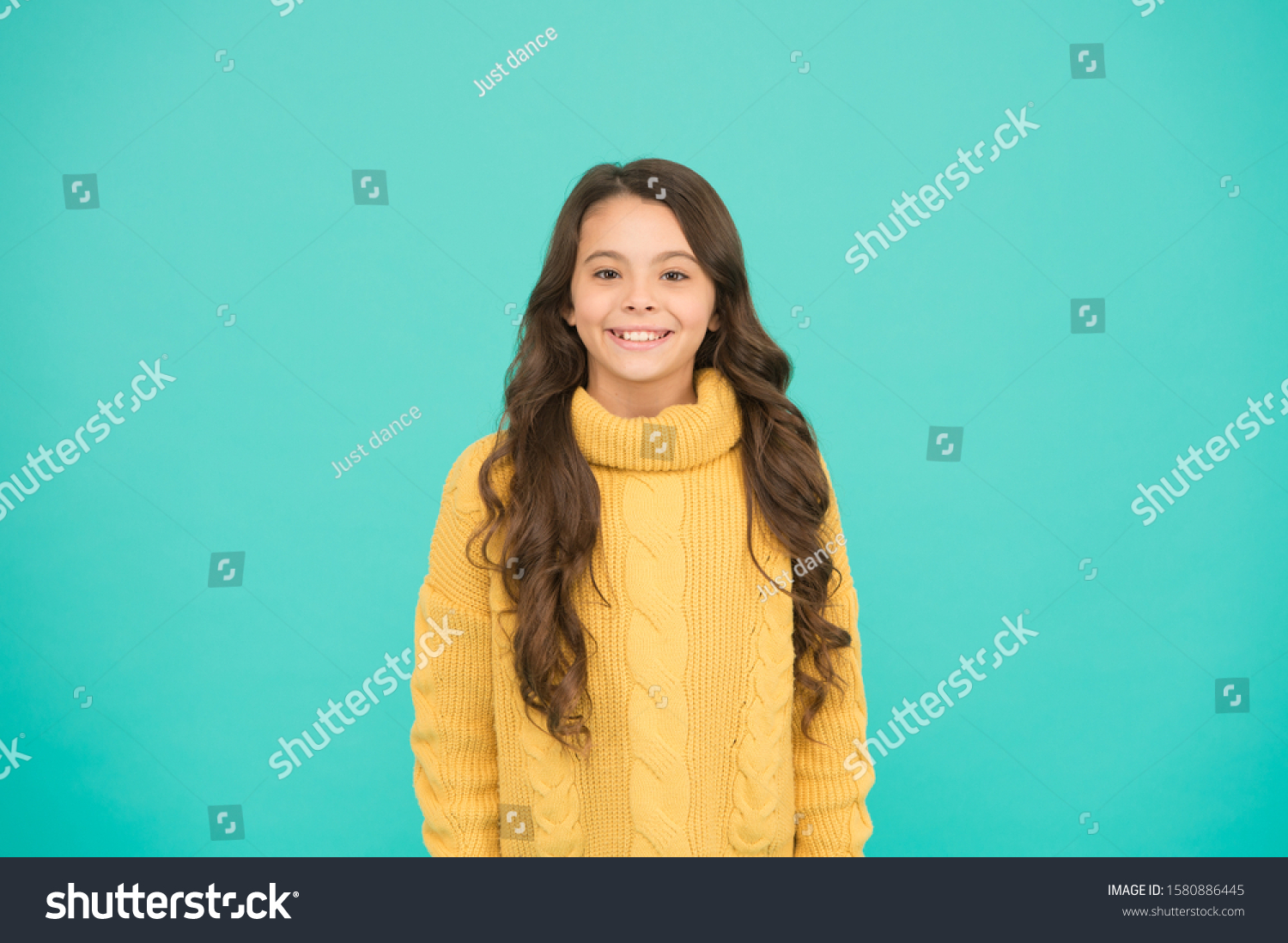 Positivity concept. Good vibes. Emotional baby. Positive child. Positive attitude to life. Inspiration. Positive mood. Kids psychology. Adorable smiling girl wear yellow sweater turquoise background. #1580886445