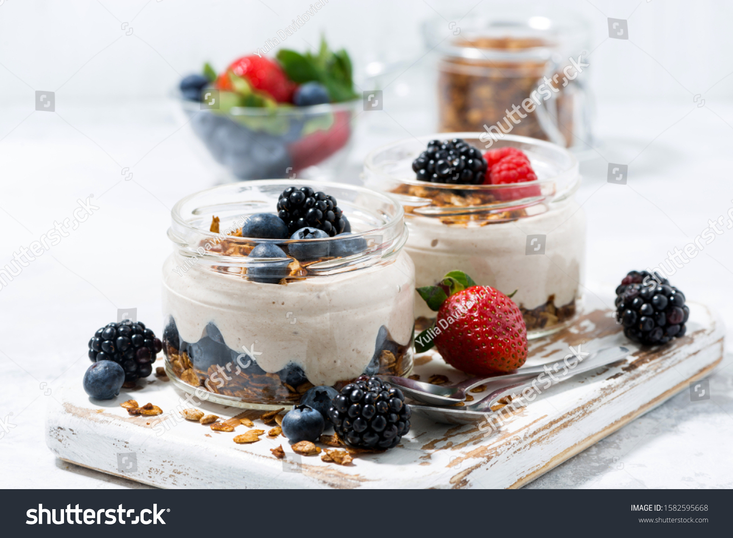 healthy creamy dessert with fresh berries on white background, closeup #1582595668