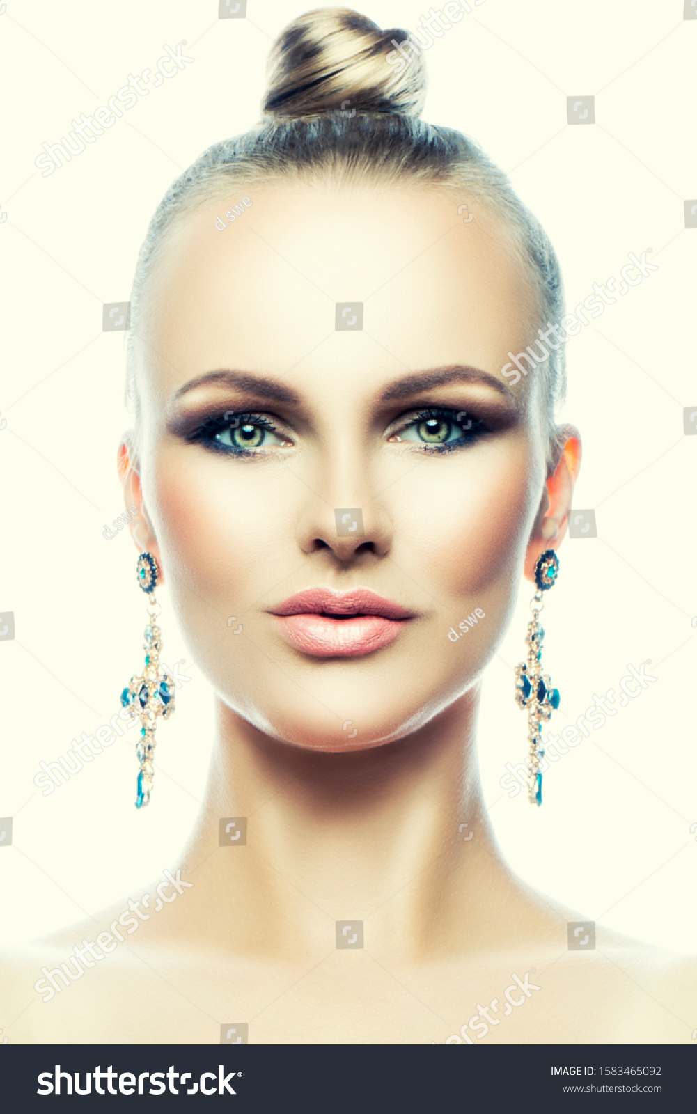 Beauty fashion model woman close-up studio portrait. Perfect skin, bright eye shadow make-up, jinny hair style, jewelry earrings.  #1583465092