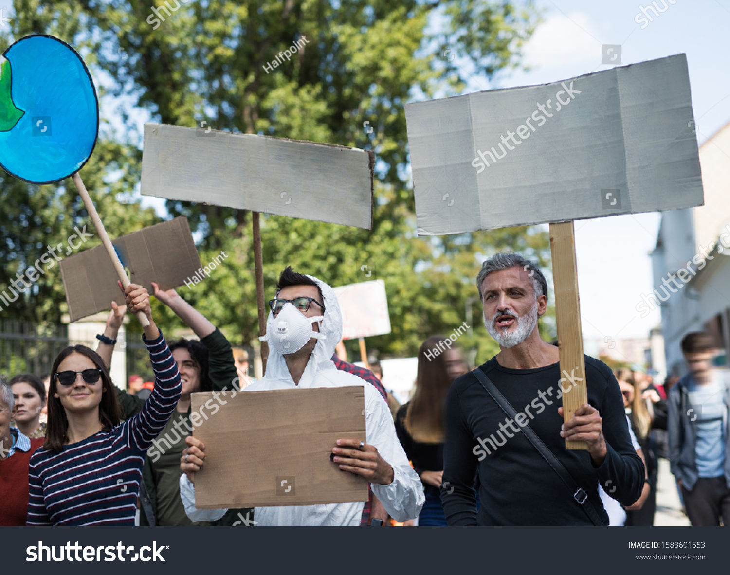 People with placards and protective suit on global strike for climate change. #1583601553