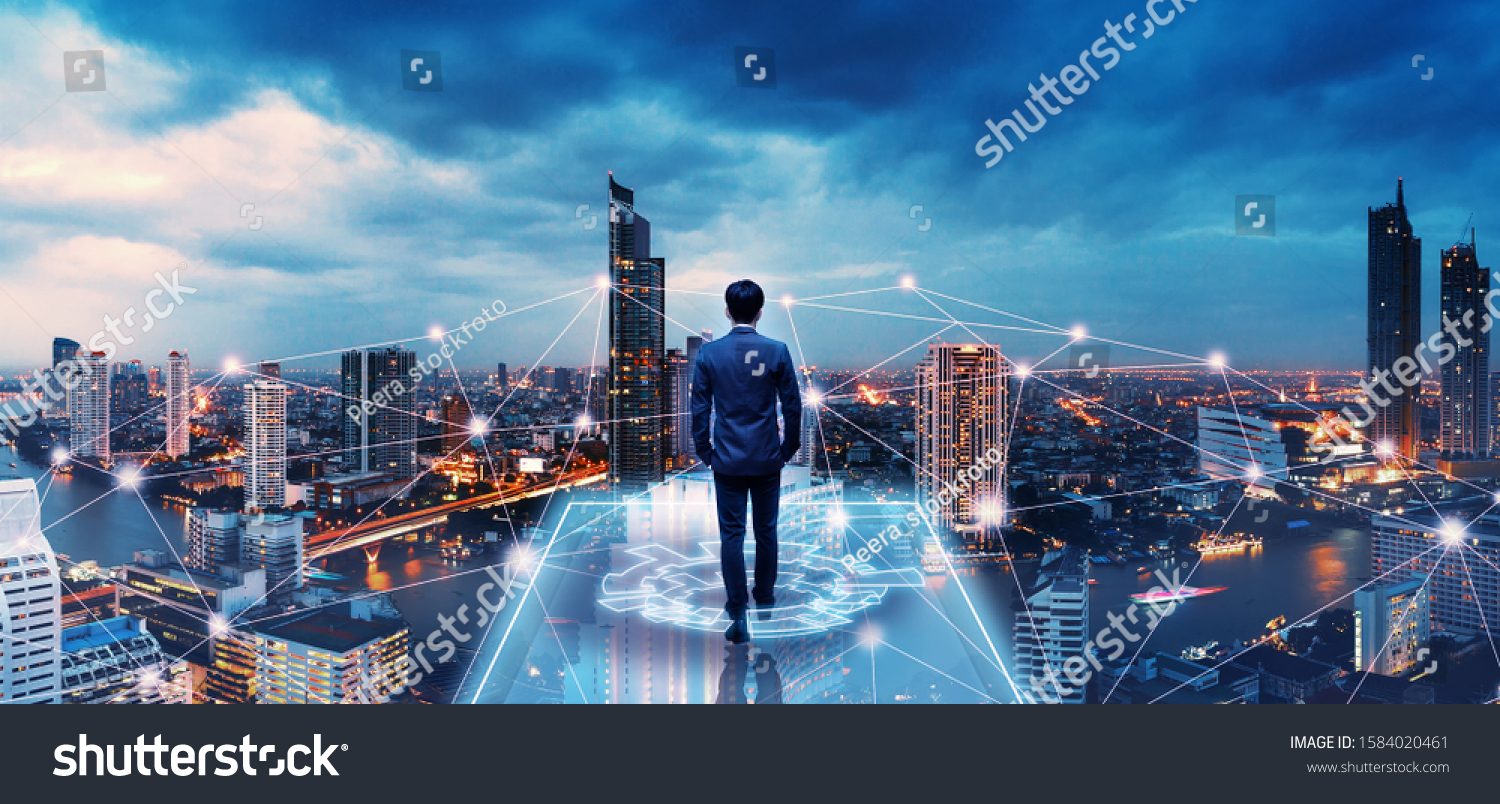 Business technology concept, Professional business man walking on future network city background and futuristic interface graphic at night, Cyberpunk color style #1584020461