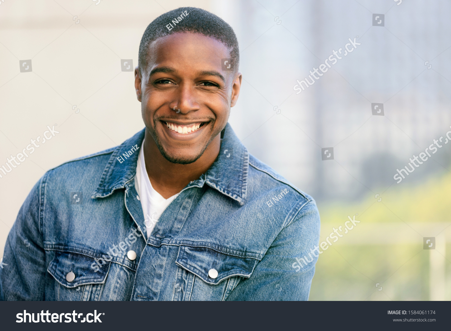 Close up head shot of a handsome commercial african american model with perfect white teeth smile after dentist, dental and orthodontic advertisement #1584061174