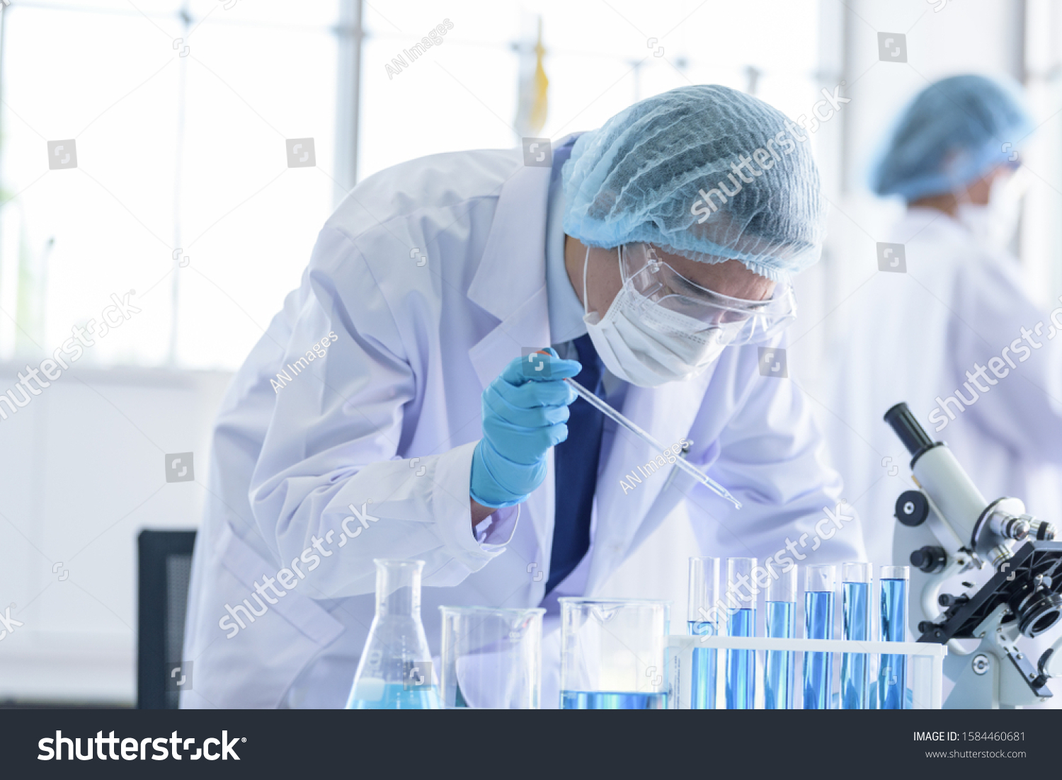 Asian scientist team has researching in laboratory. #1584460681