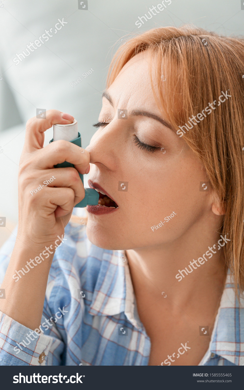 Beautiful mature woman with asthma inhaler at home #1585555465
