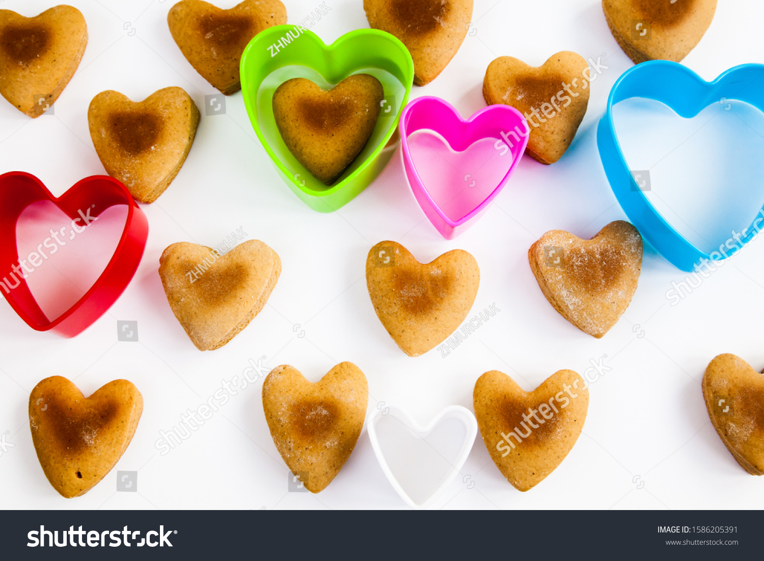 Heart shaped cookies on a white background with plastic shapes #1586205391