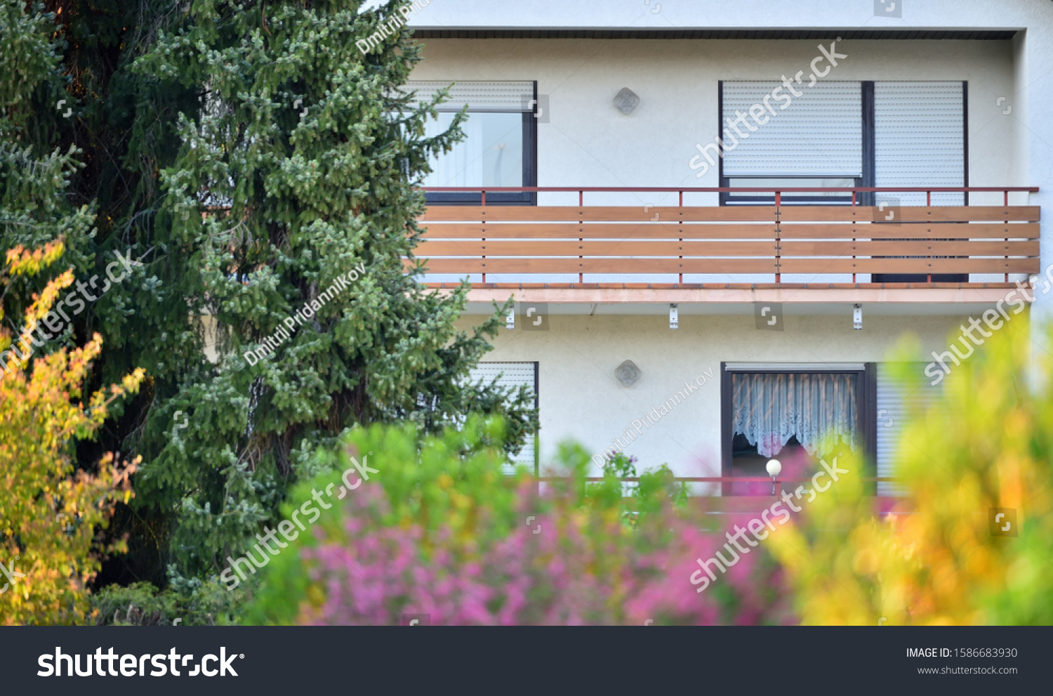 Wooden balcony of a residential building in a residential area of a European city #1586683930