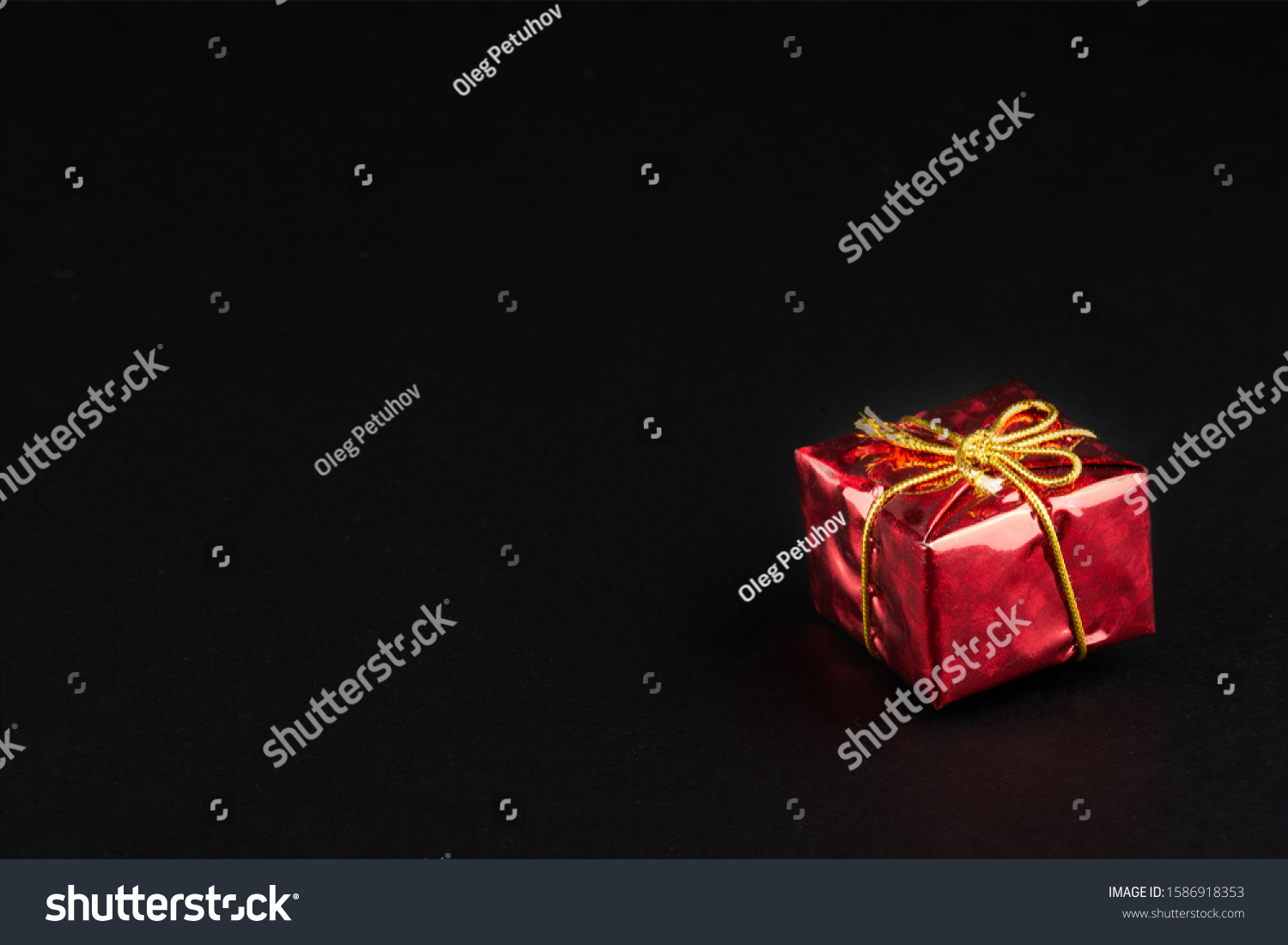 Christmass  tmass gift in red paper isolated at black background #1586918353