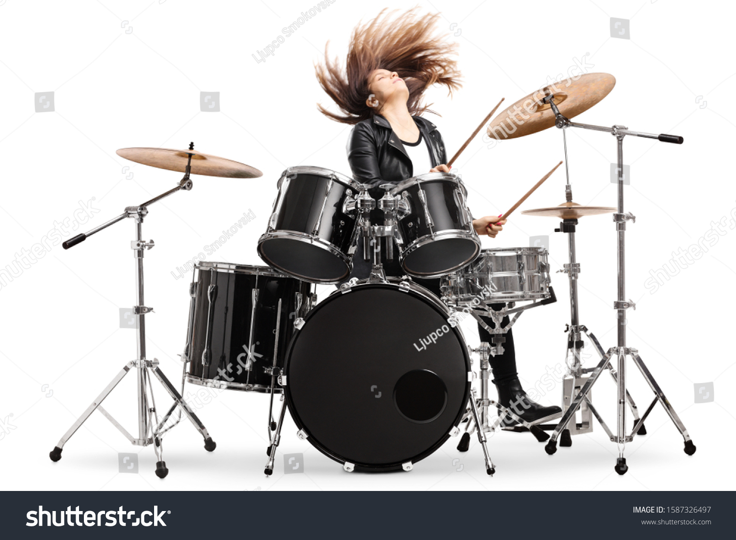 Energetic female drummer throwing her hair and playing drums isolated on white background #1587326497