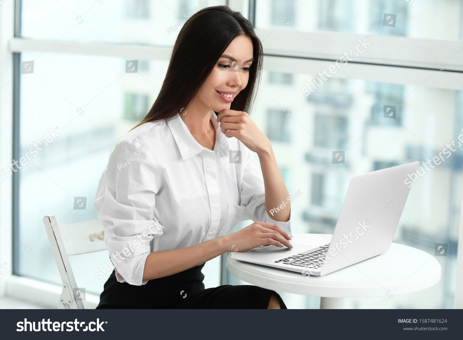 Beautiful Asian businesswoman with laptop in office #1587481624