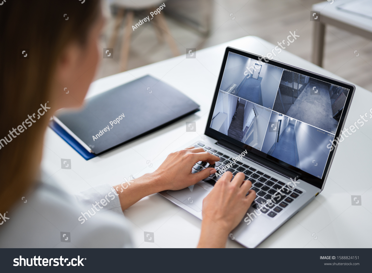 Close-up Of A Businesswoman Monitoring The CCTV Footage Of Office On Laptop #1588824151