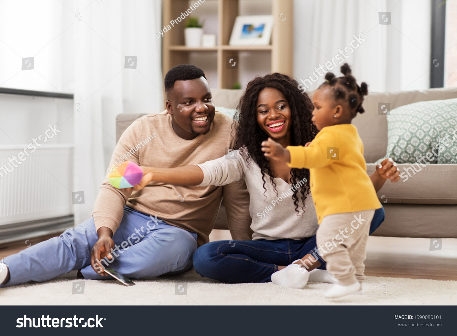 family, parenthood and people concept - happy african american mother and father playing with baby daughter at home #1590080101