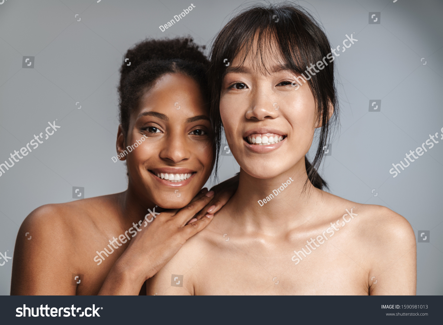 Portrait of two multinational half-naked women smiling and looking at camera isolated over grey background #1590981013