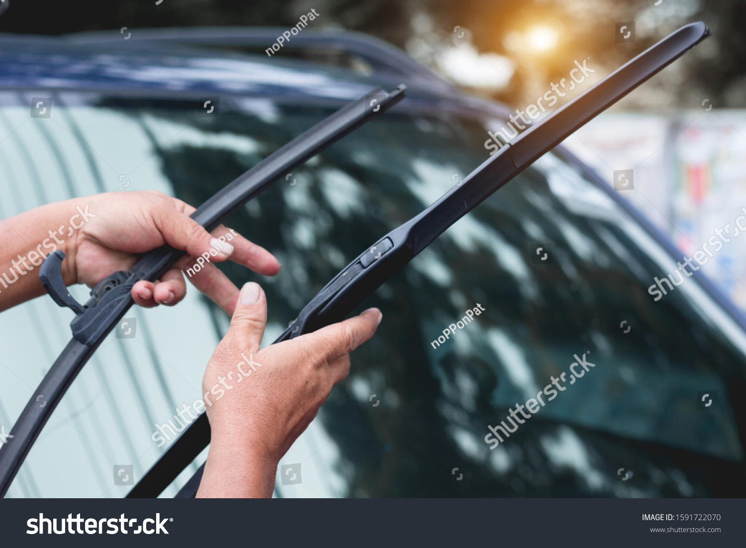 Mechanic replace windshield wipers on car. Replacing wiper blades
Change cars wiper blades. Technician Man changing windshield wipers blades on car. #1591722070