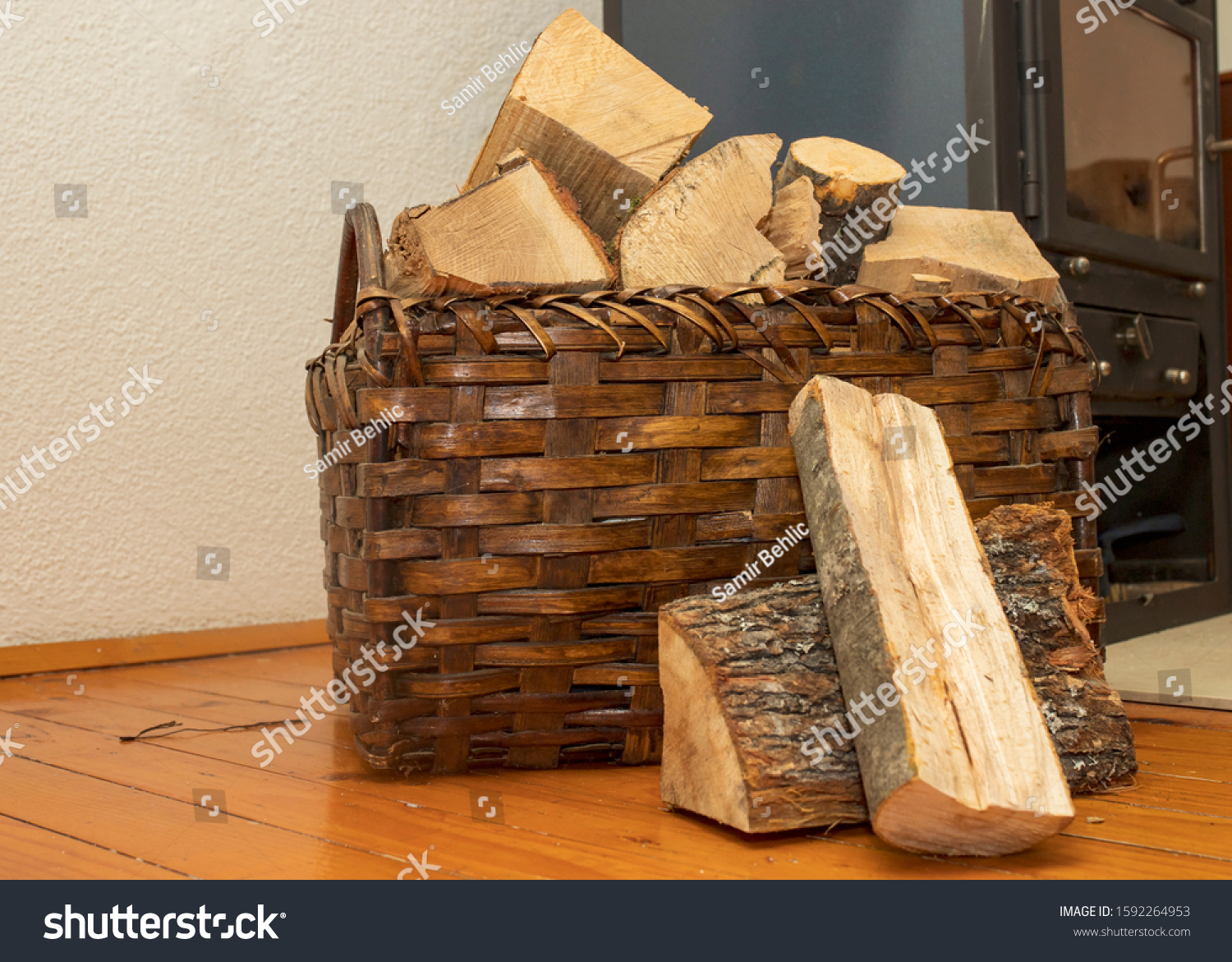
Basket with wood for fireplace and and fireplace in the background #1592264953